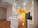 Bright kitchen featuring stainless steel appliances, white cabinets, and a breakfast bar area at 1180 Mesa Verde Ct, Clermont, FL 34711