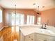 Open-concept kitchen featuring an island with seating, a sink, hardwood floors, and access to the outdoor patio at 1180 Mesa Verde Ct, Clermont, FL 34711