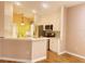 Bright kitchen featuring stainless steel appliances, white cabinets, and a breakfast bar area at 1180 Mesa Verde Ct, Clermont, FL 34711