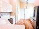 Well-lit kitchen featuring white cabinets, stainless steel appliances, and hardwood floors leading to built-in seating at 1180 Mesa Verde Ct, Clermont, FL 34711