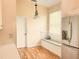 Bright kitchen nook with built-in seating, a modern refrigerator, and natural light from the window at 1180 Mesa Verde Ct, Clermont, FL 34711