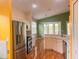 Well-lit kitchen with stainless steel appliances, white cabinetry, and an open dining area at 1180 Mesa Verde Ct, Clermont, FL 34711