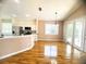 Open-concept living room and kitchen with stainless steel appliances and a sliding glass door at 1180 Mesa Verde Ct, Clermont, FL 34711