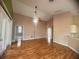 Bright, open living room with laminate floors, ceiling fan, and sliding glass doors for natural light at 1180 Mesa Verde Ct, Clermont, FL 34711