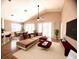 Open-concept living room with wood floors, high ceilings, comfortable sectional, and elegant decor at 1180 Mesa Verde Ct, Clermont, FL 34711