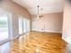 Spacious living room featuring wood floors, high ceilings, and sliding glass doors leading to a pool at 1180 Mesa Verde Ct, Clermont, FL 34711