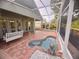 Relaxing screened-in pool area with brick pavers and a charming white porch swing for outdoor enjoyment at 1180 Mesa Verde Ct, Clermont, FL 34711