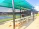 Covered tennis court benches, providing shaded seating for players and spectators during matches at 1180 Mesa Verde Ct, Clermont, FL 34711