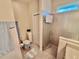 Well-lit bathroom with tile flooring, glass shower, toilet and ample storage at 12110 Grand Oak Ln, Oxford, FL 34484