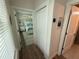 Hallway view of a bedroom featuring natural light and coastal decor at 12110 Grand Oak Ln, Oxford, FL 34484