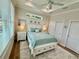 Comfortable bedroom with a decorative tray ceiling, ceiling fan, and lots of natural light at 12110 Grand Oak Ln, Oxford, FL 34484