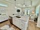 Open kitchen featuring an island with sink, granite countertops, and pendant lighting at 12110 Grand Oak Ln, Oxford, FL 34484