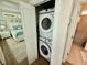 View of a bedroom, laundry closet with stacked washer/dryer, and bathroom at 12110 Grand Oak Ln, Oxford, FL 34484