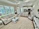 Open-concept living area with a view of the kitchen, cozy seating, and plenty of natural light at 12110 Grand Oak Ln, Oxford, FL 34484