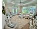 Inviting living room with large windows, comfortable seating, and a ceiling fan at 12110 Grand Oak Ln, Oxford, FL 34484