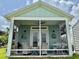 Cozy screened porch with seating, ceiling fan, and charming decor for relaxing outdoors at 12110 Grand Oak Ln, Oxford, FL 34484