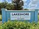 Lakeshore at Lake Andrew community sign with colorful landscaping at 12110 Grand Oak Ln, Oxford, FL 34484