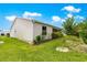 Landscaped backyard with manicured lawn and perimeter hedges at 1224 Ballesteros Dr, The Villages, FL 32162