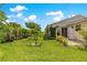 The backyard features well-maintained lawn and mature landscaping at 1224 Ballesteros Dr, The Villages, FL 32162