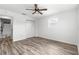 Comfortable bedroom has a ceiling fan, closet, single window, and clean, modern, wood-look floors at 1224 Ballesteros Dr, The Villages, FL 32162