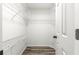 Walk-in closet with built-in shelving and wood-look floors at 1224 Ballesteros Dr, The Villages, FL 32162