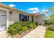 Landscaped front yard with lush bushes and colorful plants leading to a welcoming home entrance at 1224 Ballesteros Dr, The Villages, FL 32162