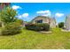 Well-maintained front yard featuring a neatly trimmed hedge and lush green lawn at 1224 Ballesteros Dr, The Villages, FL 32162