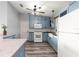 Charming kitchen featuring blue cabinets, modern appliances, mosaic backsplash and wood countertop at 1224 Ballesteros Dr, The Villages, FL 32162