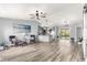 Open living space with modern vinyl floors, bright natural light and seamless kitchen access at 1224 Ballesteros Dr, The Villages, FL 32162