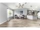 Spacious living area with an open design featuring updated flooring and seamless flow to the kitchen at 1224 Ballesteros Dr, The Villages, FL 32162
