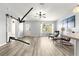 Bright living room highlighting barn door and ample natural light, complete with stylish flooring at 1224 Ballesteros Dr, The Villages, FL 32162