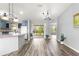 Spacious living area featuring vinyl floors, neutral paint, a large glass slider and kitchen view at 1224 Ballesteros Dr, The Villages, FL 32162