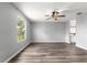 Bright living room features modern ceiling fan, neutral walls, and stylish laminate flooring at 1224 Ballesteros Dr, The Villages, FL 32162