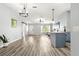 Open living area with vinyl floors, modern paint, barn door, and contemporary lighting at 1224 Ballesteros Dr, The Villages, FL 32162