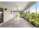 Enclosed patio with neutral color walls, ceiling fan, and glass door to the backyard at 1224 Ballesteros Dr, The Villages, FL 32162