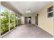 Enclosed patio with neutral color walls, ceiling fan, and view to the outside at 1224 Ballesteros Dr, The Villages, FL 32162