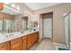 Bright bathroom featuring a soaking tub, glass shower, and dual vanity sinks at 12947 Se 97Th Terrace Rd, Summerfield, FL 34491