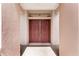 View of the mahogany double front doors, complemented by a transom window at 12947 Se 97Th Terrace Rd, Summerfield, FL 34491