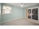 Bright bedroom with natural light and access to a sunroom through a sliding door at 1301 Cambridge Dr, Leesburg, FL 34748