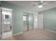 Spacious bedroom with neutral walls and a mirrored closet at 1301 Cambridge Dr, Leesburg, FL 34748