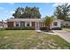Charming single-story brick home featuring a well-maintained lawn and quaint landscaping at 1301 Cambridge Dr, Leesburg, FL 34748