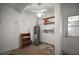 Garage with a water heater, shelving, and a white door at 1301 Cambridge Dr, Leesburg, FL 34748