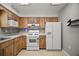 Well-lit kitchen with modern appliances and wood cabinets at 1301 Cambridge Dr, Leesburg, FL 34748