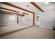 Spacious living room with ceiling fans, exposed beams, and neutral carpet at 1301 Cambridge Dr, Leesburg, FL 34748
