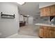 Open-concept living area with neutral walls, carpet, and a dining set beyond at 1301 Cambridge Dr, Leesburg, FL 34748