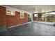 Enclosed patio with a fan overhead and a red brick exterior at 1301 Cambridge Dr, Leesburg, FL 34748