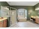 Bathroom with a soaking tub, shower, tile flooring, and vanity with neutral paint at 1351 Legendary Blvd, Clermont, FL 34711
