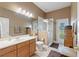 Bathroom featuring a glass shower, toilet, sink, and ample lighting in a neutrally painted room at 1351 Legendary Blvd, Clermont, FL 34711