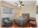 Bedroom with a bed, hardwood floors, a ceiling fan, and a window with blinds at 1351 Legendary Blvd, Clermont, FL 34711