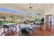 Bright dining area with wood floors, ceiling fan, and large windows overlooking the community's outdoor facilities at 1351 Legendary Blvd, Clermont, FL 34711